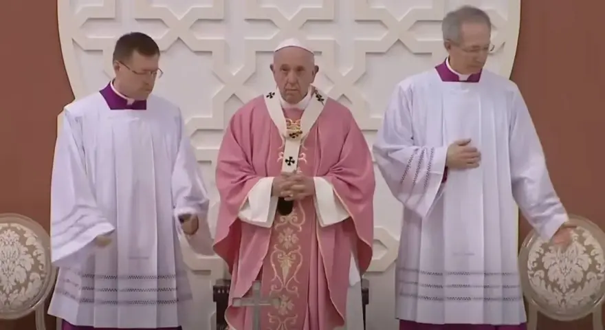 Pope Francis, in a pink vestment for the fourth Sunday of Lent, stands between two clergy members in white albs.