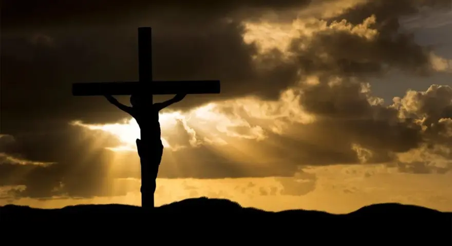 Silhouette of Jesus on the cross against a dramatic sky. His sacrifice shows Jesus died for our sins, offering hope.