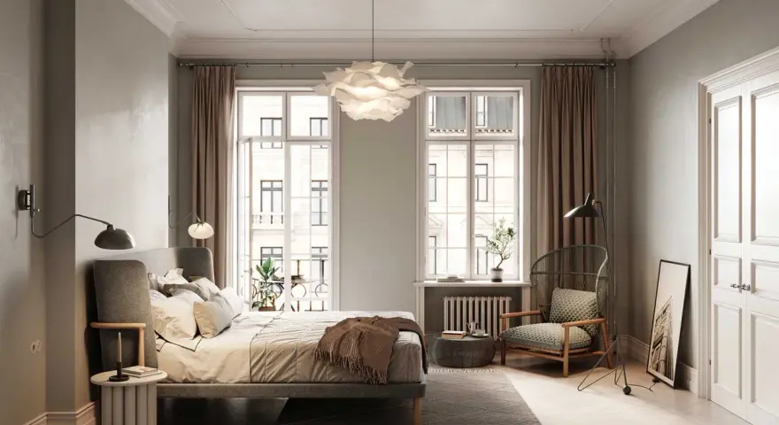 Un elegante bonsai in camera da letto, accanto a un letto accogliente e una poltrona in vimini, crea un'oasi di pace.