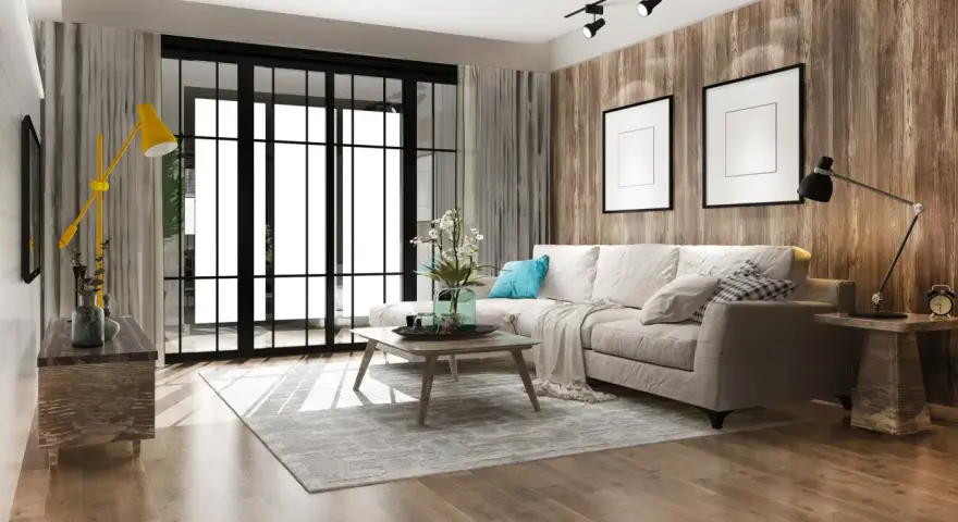 Soggiorno accogliente con divano beige, tavolino in legno e lampada gialla. Un esempio di come arredare casa con poco, creando stile e comfort.