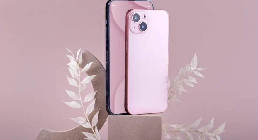 Dwa telefony, jeden ciemny, drugi różowy iPhone 11, stoją na kamiennych podstawkach, ozdobione delikatnymi, białymi gałązkami.