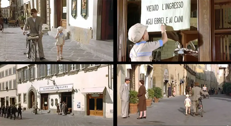 Scena di film girati ad Arezzo: un bambino legge un cartello "Vietato l'ingresso agli ebrei e ai cani", un padre e figlio passeggiano, un caffè storico e una strada con persone.