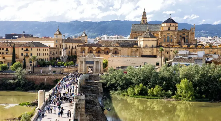 A bustling Roman bridge leads to the historic Mezquita-Cathedral of Córdoba. This view makes you wonder how many days in Córdoba are enough to explore its wonders.