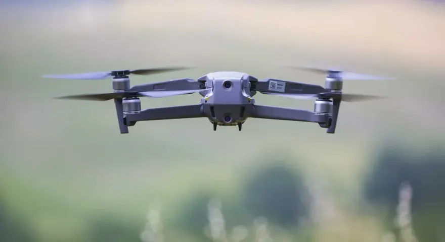 A drone hovers mid-air, its propellers blurred with motion. Planning to fly one in the Dominican Republic? Be sure to check the Dominican Republic drone laws first.