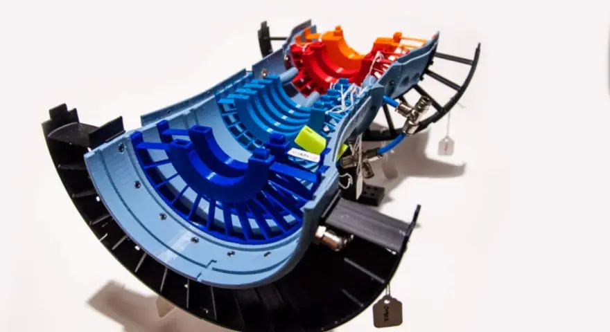 A colorful 3D printed model of a jet engine turbine, showcasing advancements in 3D printing aerospace technology.