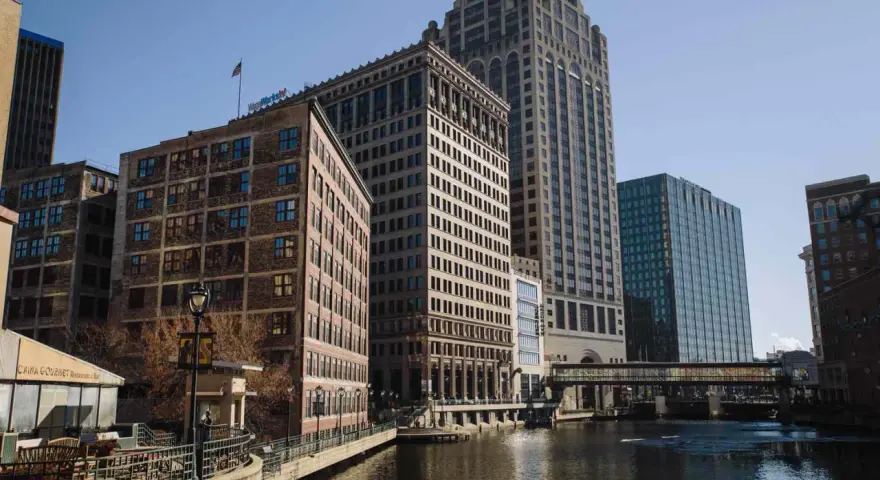 A scenic view of Milwaukee's riverfront buildings, perfect for a weekend getaway.