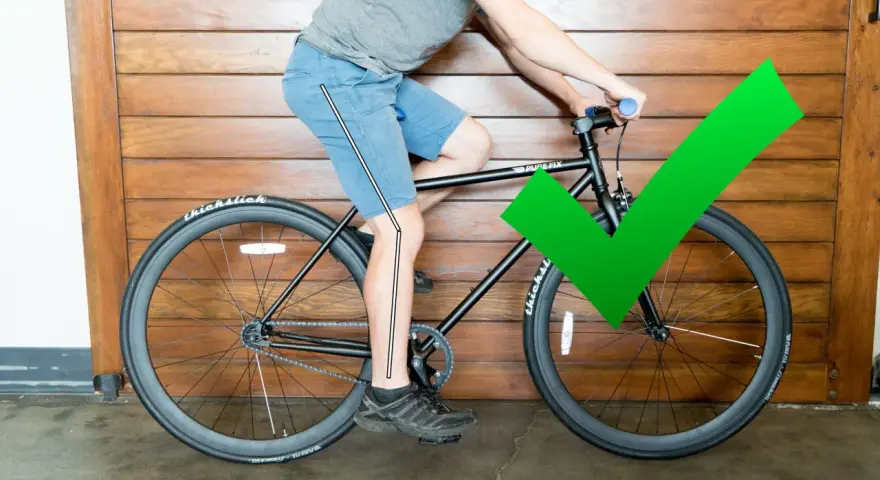 A cyclist demonstrates proper bike seat height with a slight knee bend at the bottom of the pedal stroke. A green checkmark confirms the correct adjustment.