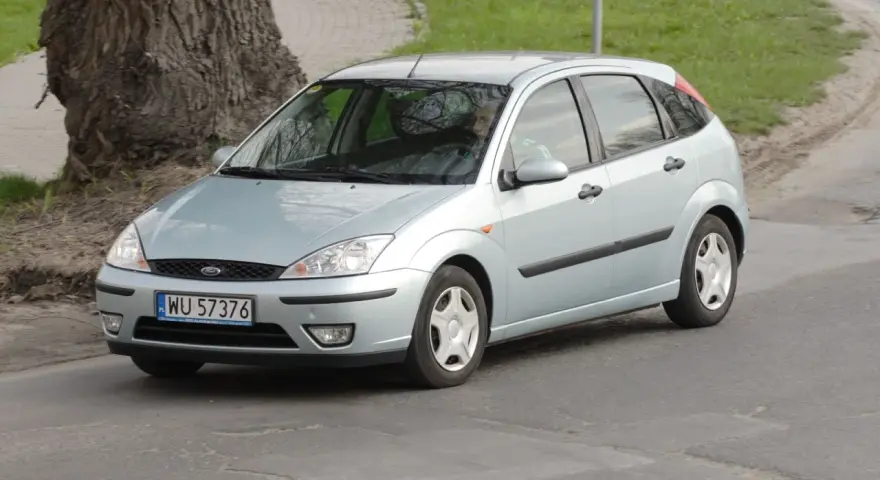 Srebrny Ford Focus, idealny dla szukających tanich samochodów do 3000 zł, jedzie po drodze.