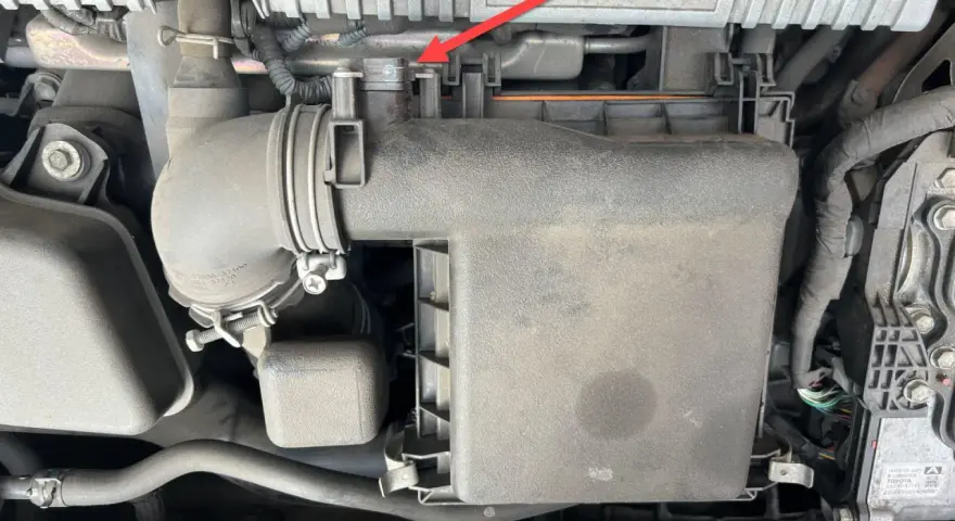 A red arrow points to a clip on the air intake system of a Toyota Hybrid Synergy Drive. This could be related to a p0102 code.