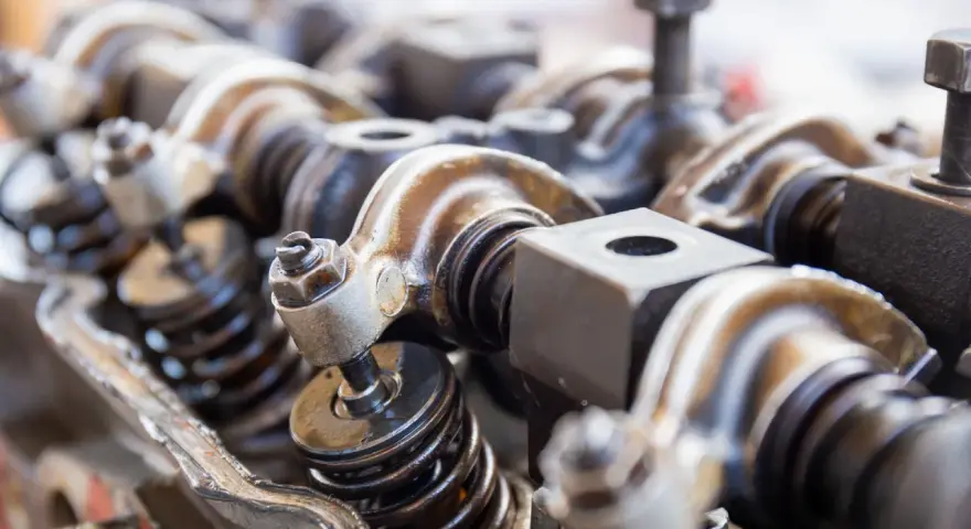 Close-up of engine valve train components, hinting at a camshaft sensor replacement.
