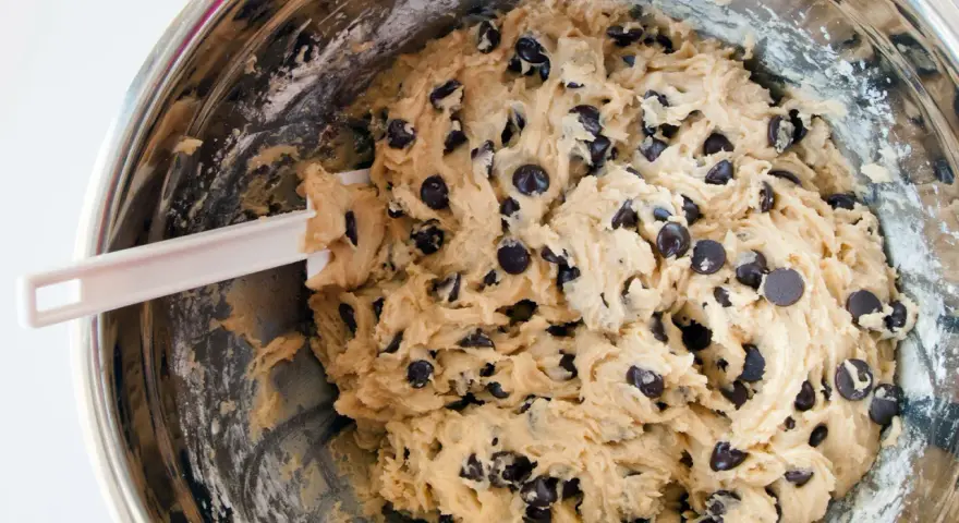 Impasto per biscotti fatti in casa con gocce di cioccolato, pronto per essere infornato.