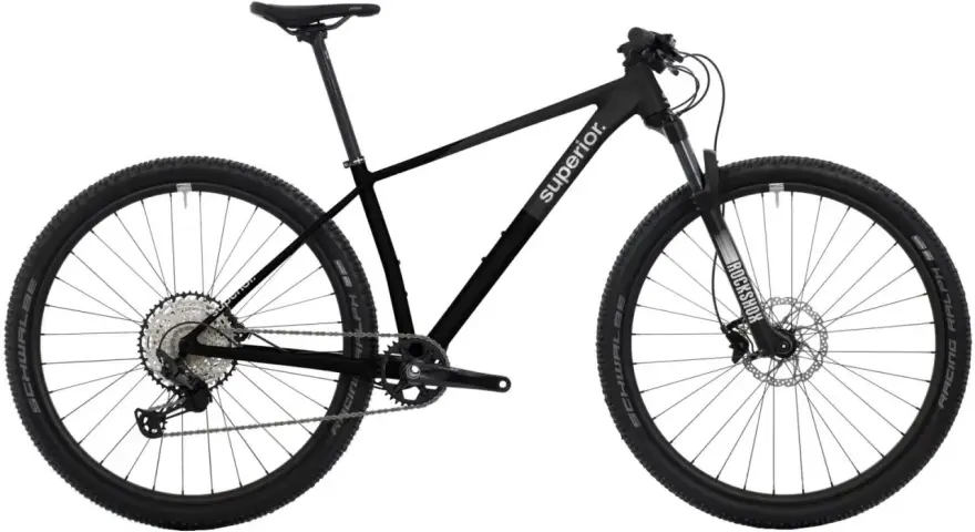 Sleek black mountain bike with "Superior." branding, ready for any road or trail. Features RockShox fork and Schwalbe tires.