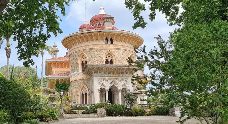 The stunning Monserrate Palace in Portugal, a fairytale castle surrounded by lush greenery and exotic plants.