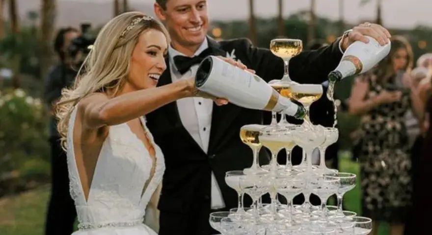 Para ratować wizerunek po weselu, gdy alkohol wziął górę, para młoda nalewa szampana na wieżę kieliszków.