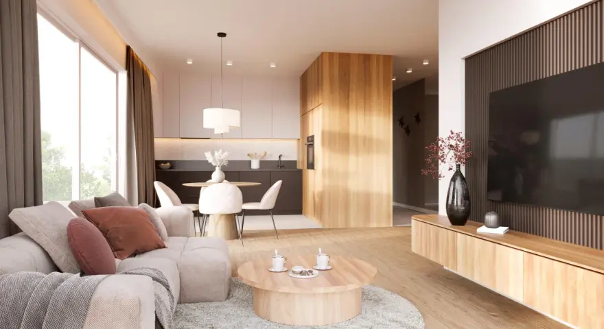 Przytulny salon z sofą, stolikiem kawowym i aneksem kuchennym w stylu japandi. Drewniane elementy i neutralne kolory tworzą harmonijną przestrzeń.