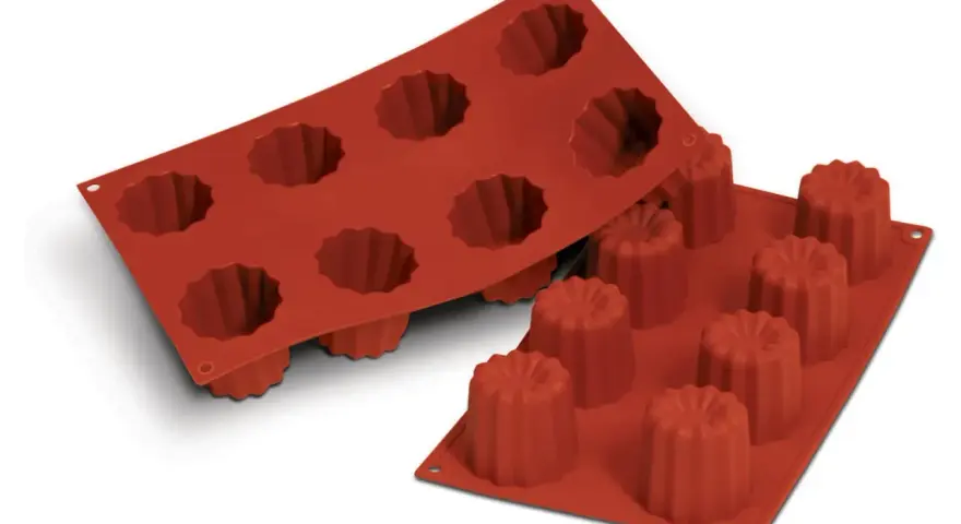 Deux moules en silicone rouge pour cannelés, prêts pour votre prochaine recette.