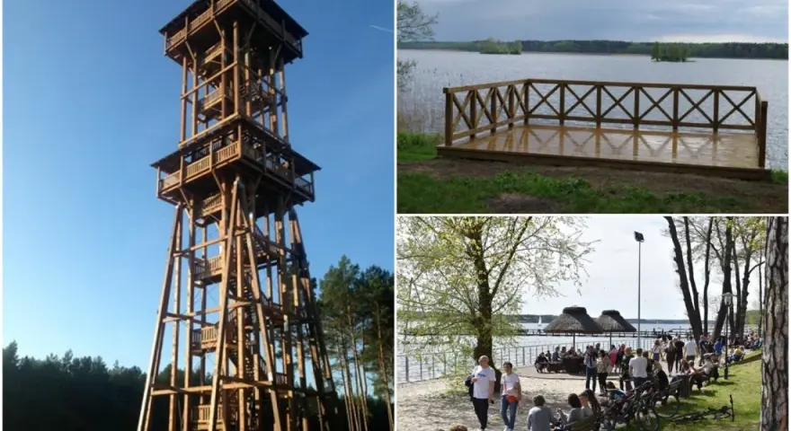 Wysoka, drewniana wieża widokowa Joanna góruje nad lasem. Obok jezioro z pomostem i plaża z ludźmi.