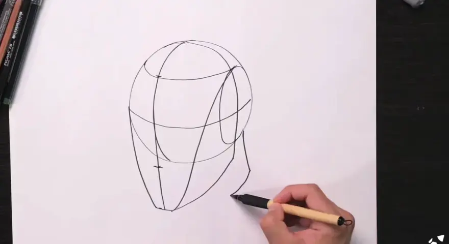 Un boceto de cabeza con líneas guía, parte de una lección de retratos fáciles.