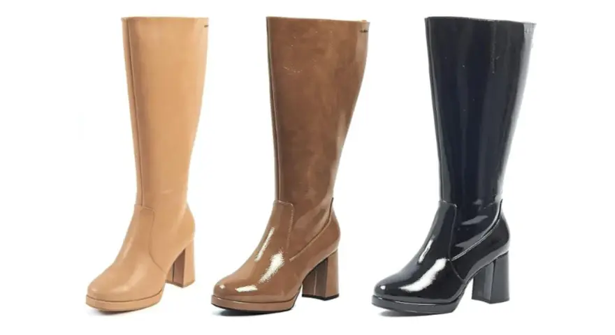Tres botas altas de tacón, una beige de cuero, otra marrón brillante y una negra charol. La caña de una bota es la parte que cubre la pierna.