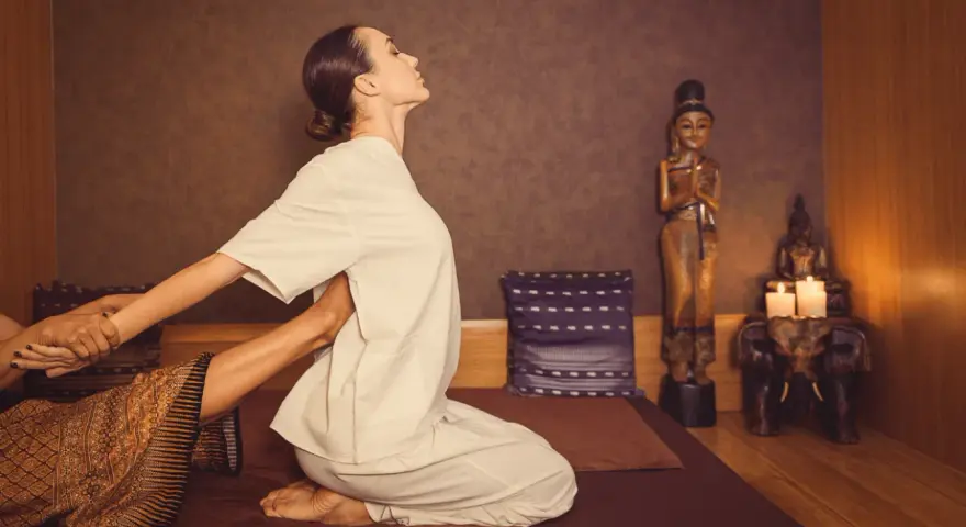 A woman receives a traditional Thai massage, a practice with a rich history rooted in ancient healing traditions.