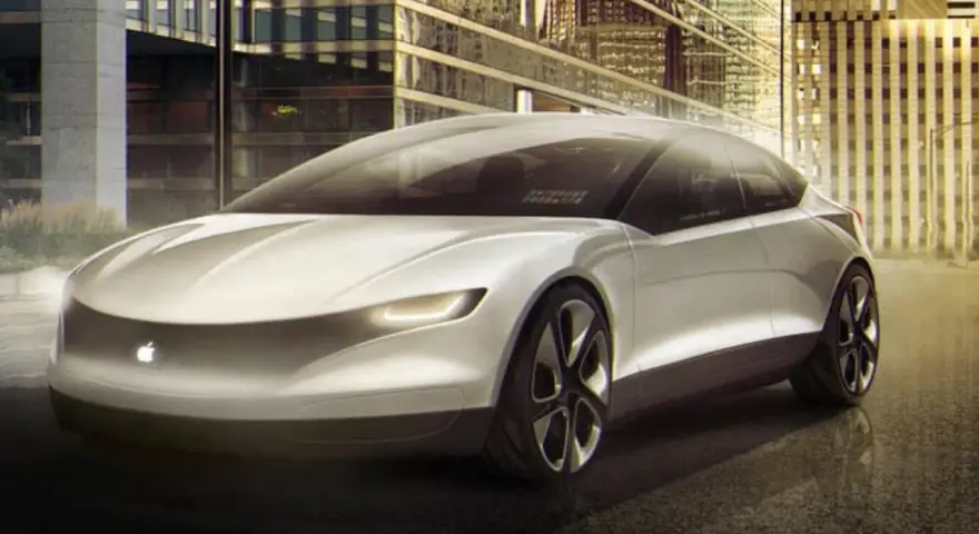 Futurystyczny, biały apple car z podświetlanym logo jabłka, zaparkowany przed nowoczesnymi budynkami w nocy.