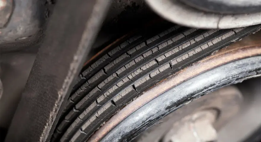 Cracked serpentine belt, a common cause of belt failure, shows signs of wear and tear.