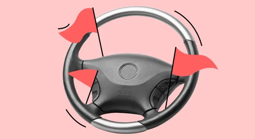 Lenkrad mit roten Flaggen, die auf einen hohen Kilometerstand des Autos hinweisen.