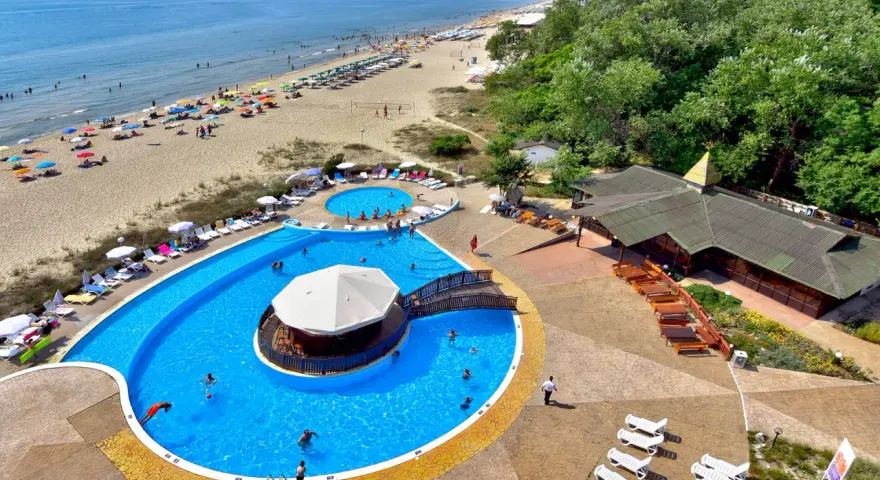 Słoneczny dzień w Albena Bułgaria. Ludzie odpoczywają na plaży i kąpią się w basenie z barem.