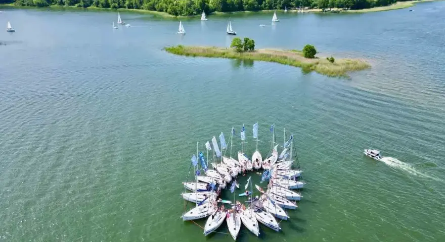 Mazury, gdzie jechać? Zobacz krąg żaglówek na jeziorze, las i małą wyspę. Idealne miejsce na wakacje!
