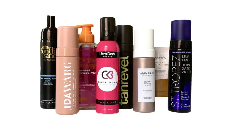En samling av olika märken av dha brun utan sol-produkter, inklusive mousser och lotions, i olika nyanser.