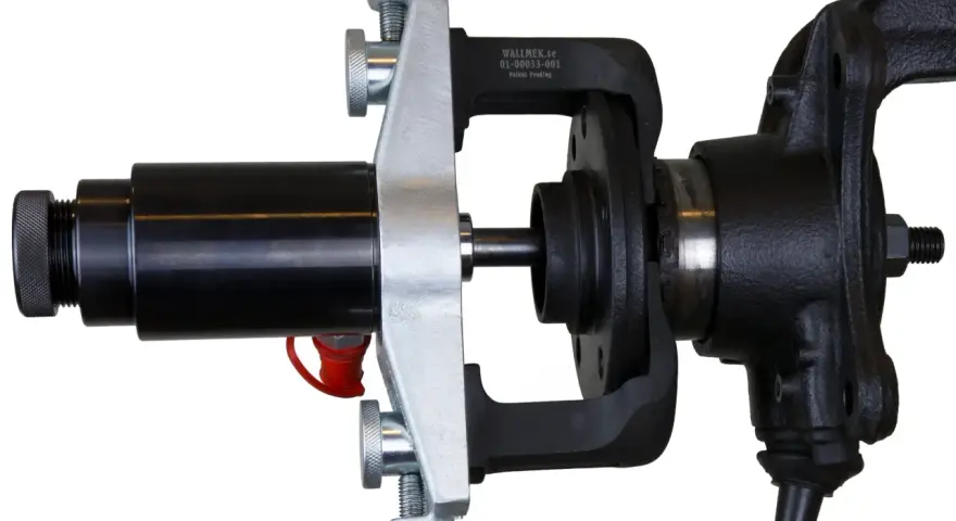 Automotive hub bearing removal and installation tool with a black hydraulic cylinder and silver clamp.