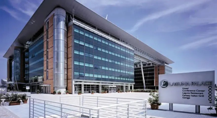Modern hotel building with glass facade and a sign for Laguna Palace.