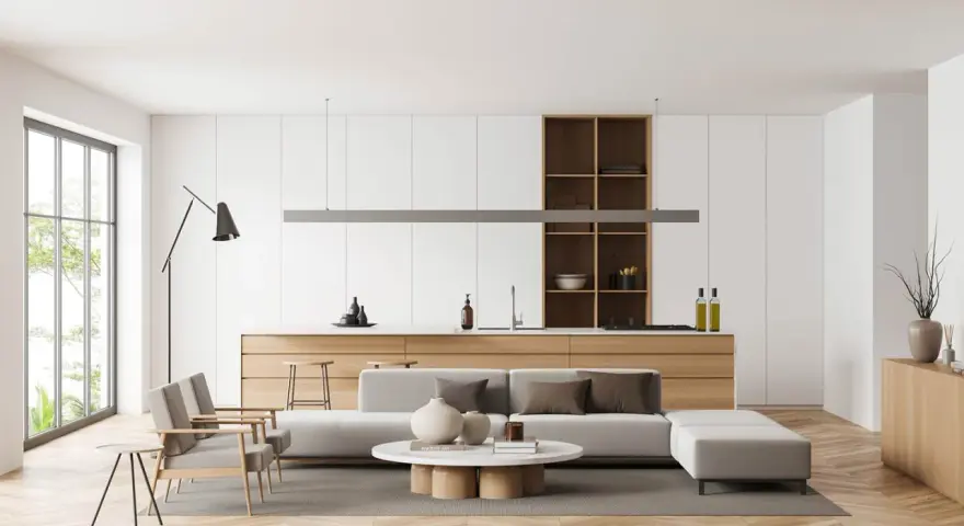 Soggiorno e cucina open space con mobili contemporanei moderni, divano, tavolino e isola.