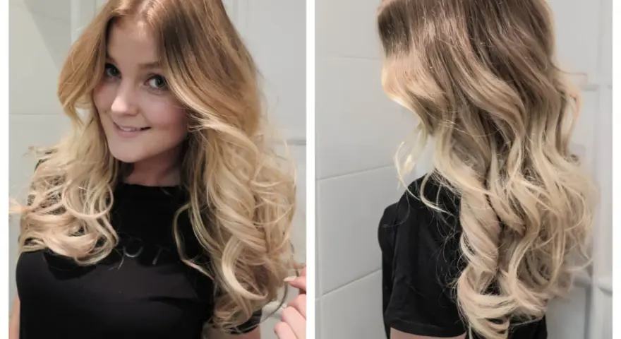 Vacker kvinna med axellångt hår som är stylat i mjuka lockar.