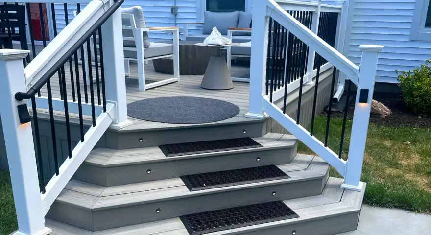 A beautifully lit deck staircase, showcasing how to build deck stairs with integrated lighting and non-slip mats.