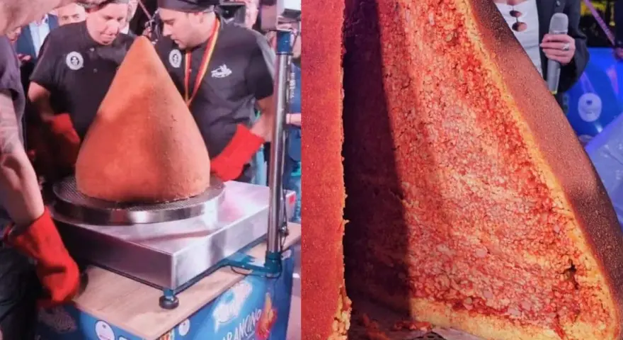 A giant arancino is presented, with a slice cut to reveal its rice and meat filling.