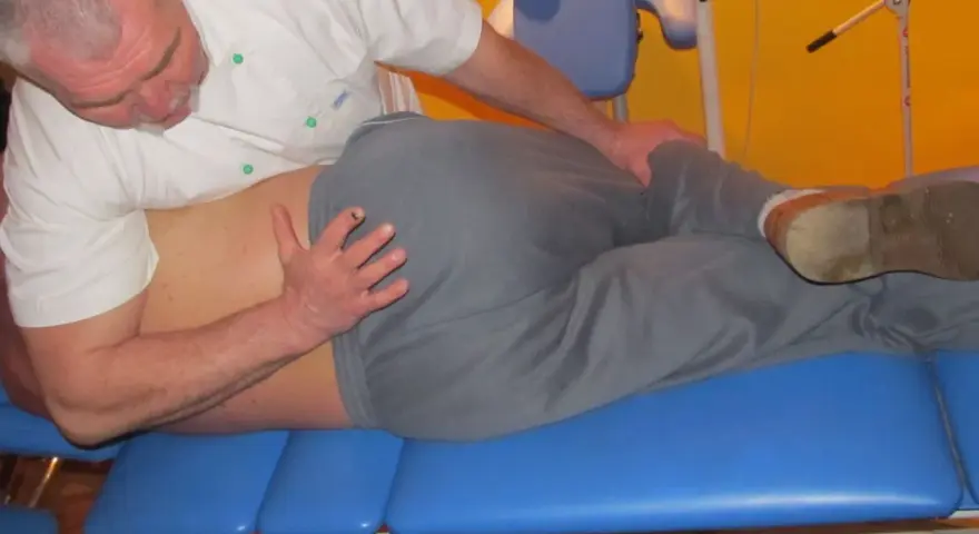 Fizjoterapeuta wykonuje terapię manualną, pomagając pacjentowi odzyskać sprawność.