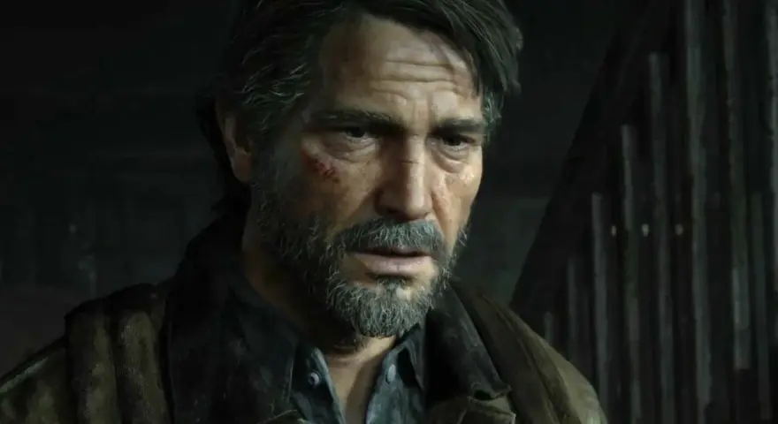 Zmęczony Joel z blizną na policzku, w brązowej kurtce, wygląda jakby czekał na wydarzenia z The Last of Us 3.