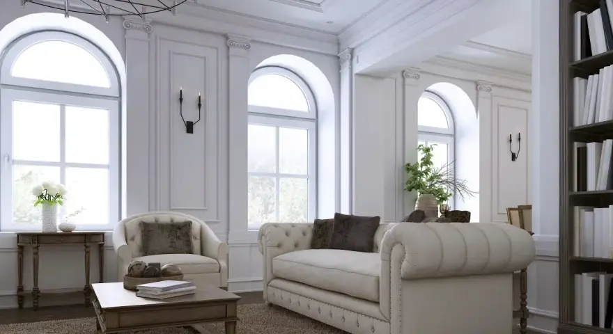 Elegancki salon z sofą, fotelem i książkami na półce.
