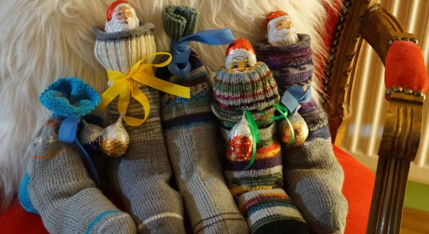 Gestrickte Nikolausstiefel mit Schokoladen-Nikoläusen und Kugeln. Wann ist Nikolaustag? Bald!