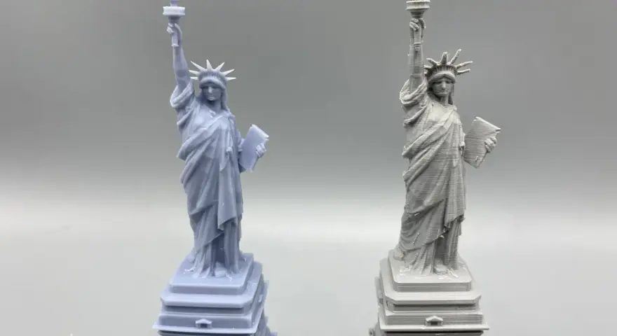 Two Statue of Liberty models: one smooth, likely resin vs. filament 3d printer with visible layer lines.