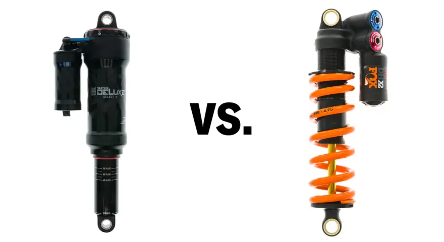 A black air shock and an orange coil shock are shown side-by-side, illustrating the coil vs air shock debate for mountain bikes.