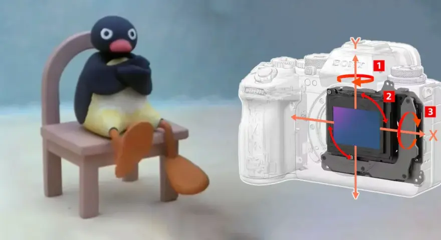 Pingu siedzi na krześle obok aparatu z widocznym mechanizmem optycznej stabilizacji obrazu, który kompensuje ruchy.