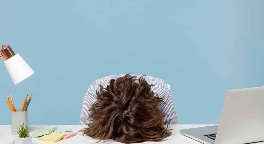 Testa affondata sulla scrivania, con un laptop aperto e post-it colorati. La sensazione è chiara: non voglio tornare a lavoro.