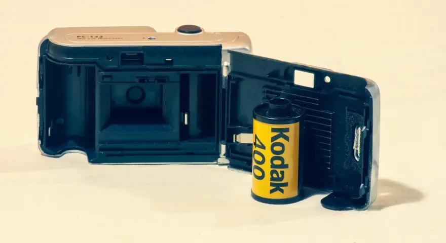 Otwarta klapka aparatu z włożonym rolką filmu Kodak 400. Klasyczny film analogowy gotowy do uchwycenia wspomnień.