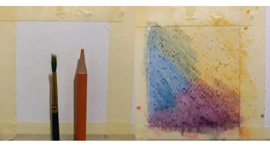 Un pinceau et un crayon aquarelle orange sont prêts pour l'utilisation. Une zone de papier présente des dégradés de couleurs vives.