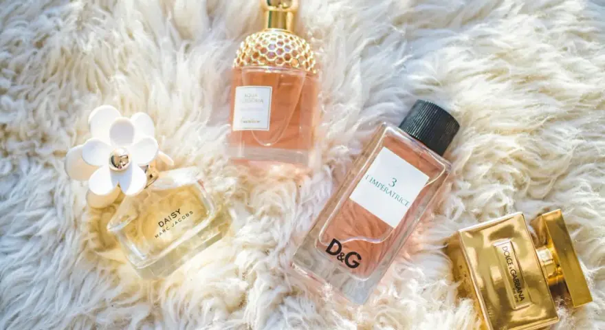 Kolekcja luksusowych perfum damskich: Daisy, Aqua Allegoria, L'Impératrice D&G i The One Dolce & Gabbana na puszystym tle.