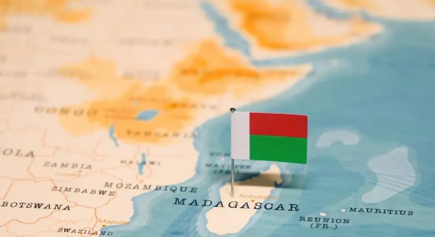 Flaga Madagaskaru na mapie. Widoczna jest Afryka i wyspa, gdzie leży Madagaskar, obok Mozambiku.