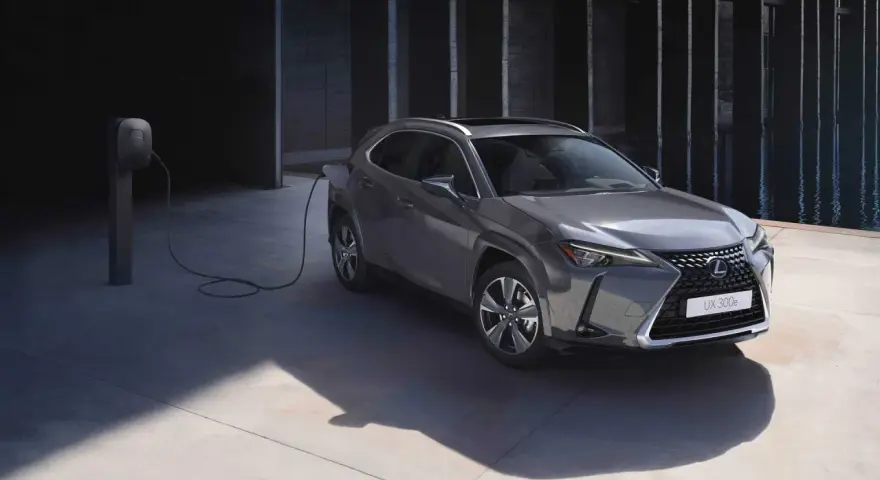 Szary Lexus UX 300e podłączony do ładowarki, gotowy na ekologiczną podróż.
