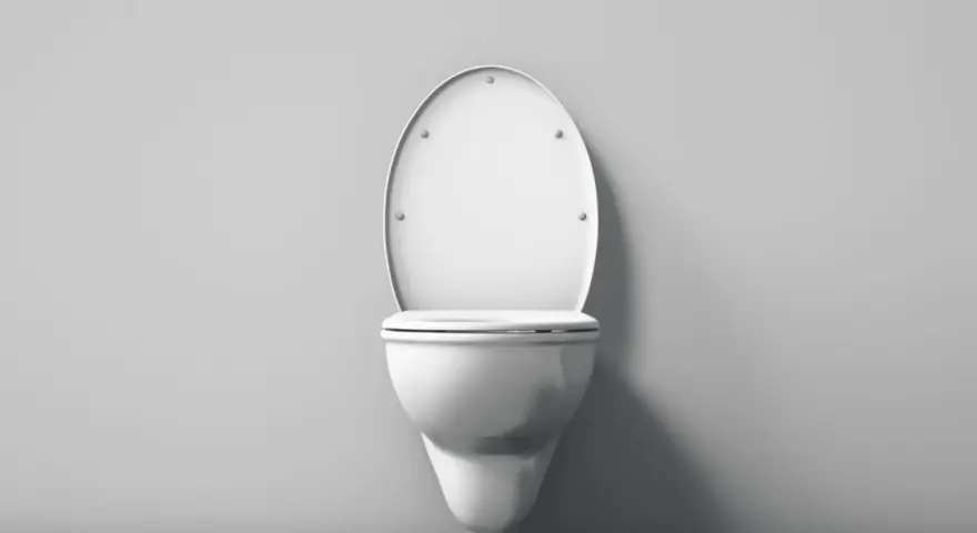 Biała, wisząca miska WC z klapą z duroplastu, zamontowana na szarej ścianie.